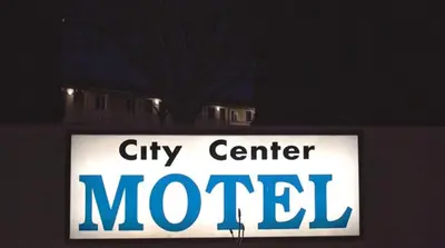 a sign for a city center motel in front of a house at City Center Motel - Oxnard in Oxnard