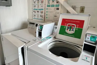 a washing machine with a box on top of it at Magnolia Apt in Los Angeles