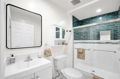 a bathroom with a toilet and a sink and a shower at Magnolia Apt in Los Angeles