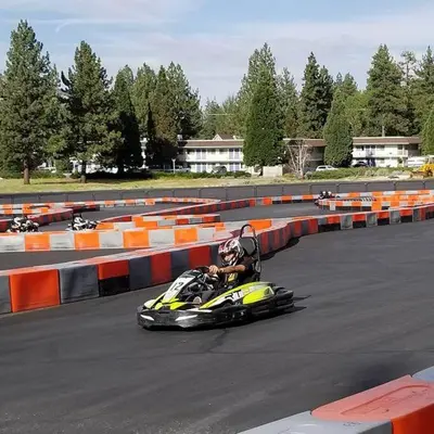 a person riding a motorcycle on a race track at The Blue Lake Cabin! 1 min Walk to SnowPlay! in Big Bear City