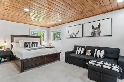 a bedroom with a bed and a couch at The RobinHood Retreat! A 1 min Walk to SnowPlay! in Big Bear City