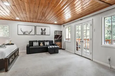 a bedroom with a bed and a couch at The RobinHood Retreat! A 1 min Walk to SnowPlay! in Big Bear City
