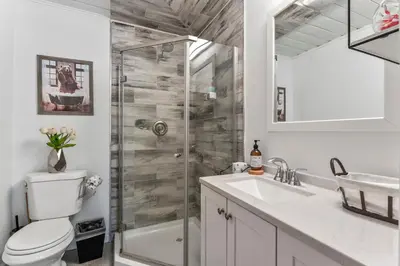 a bathroom with a shower and a toilet and a sink at The RobinHood Retreat! A 1 min Walk to SnowPlay! in Big Bear City