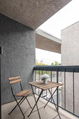 a table and a chair on a balcony at Skyline Terrace Executive Jr One Bedroom with Balcony and Pool in Los Angeles