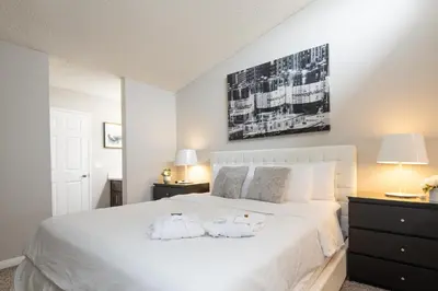a bedroom with a white bed with two pillows on it at Skyline Terrace Executive Jr One Bedroom with Balcony and Pool in Los Angeles