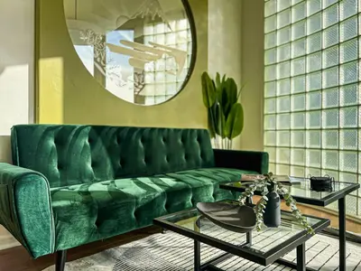 a living room with a green couch and a mirror at Stylish Residence in Los Angeles - OL-WH in Los Angeles