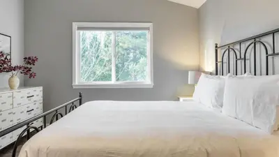a bedroom with a large bed and a window at North Bay by AvantStay Chic Retreat w Peloton in Blue Jay