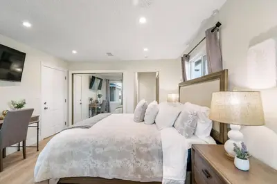 a bedroom with a large white bed and a desk at Gameroom Sofi Stadium Forum Backyard BBQ in Hawthorne