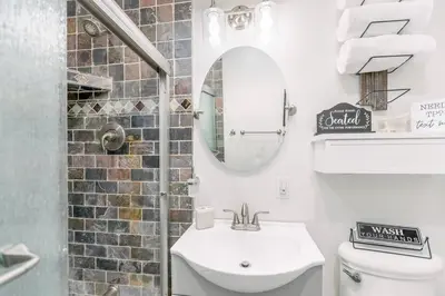 a bathroom with a sink and a mirror and a toilet at Gameroom Sofi Stadium Forum Backyard BBQ in Hawthorne