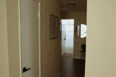 a hallway with a door with a mirror and a mirror at Cozy Family Home - 20 Mins from Disneyland in Placentia