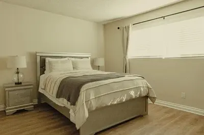 a bedroom with a large bed and a window at Cozy Family Home - 20 Mins from Disneyland in Placentia
