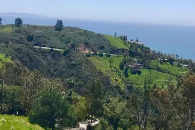 a green hill with a train on it at Malibu Secluded Escape Ocean View Zen House in Malibu