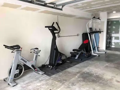a room with several bikes and exercise machines in it at Malibu Secluded Escape Ocean View Zen House in Malibu