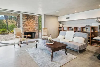 a living room with a couch and a fireplace at Malibu Glass House: Architectural w 180deg Views in Malibu