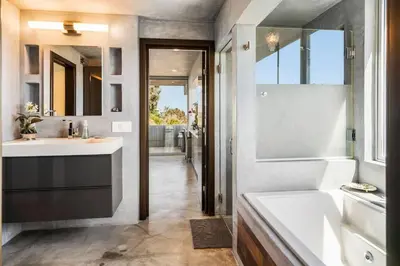 a bathroom with a tub and a sink and a bath tub at Malibu Glass House: Architectural w 180deg Views in Malibu