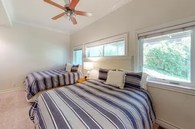 two beds in a bedroom with a ceiling fan at Bayfront Beauty - Main in Lake Arrowhead
