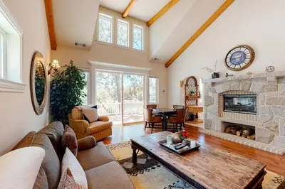a living room with a couch and a fireplace at Bayfront Beauty - Main in Lake Arrowhead