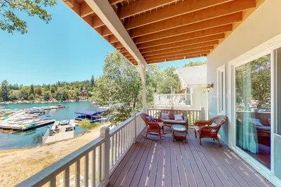 a porch with a view of the water and boats at Bayfront Beauty - Main in Lake Arrowhead