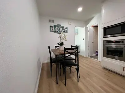 a dining room with a table and chairs and a fireplace at Modern 4 King Beds, Beautiful Large Backyard, Golf, WFH, Long Stays, WI-FI, FWY, 25 mins to Beach in Casa Conejo