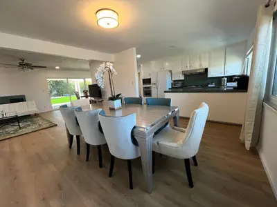 a kitchen and dining room with a table and chairs at Modern 4 King Beds, Beautiful Large Backyard, Golf, WFH, Long Stays, WI-FI, FWY, 25 mins to Beach in Casa Conejo