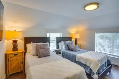 a bedroom with two beds and two lamps and a window at Super Walkable! Historic Home in Dtwn Long Beach in Long Beach