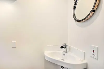 a bathroom with a sink and a mirror on the wall at Super Walkable! Historic Home in Dtwn Long Beach in Long Beach