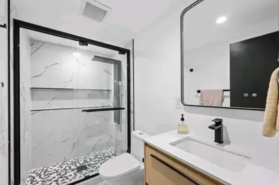 a bathroom with a shower and a toilet and a sink at Updated Mountain Cabin Retreat with 180 views off Deck and Balcony in Running Springs