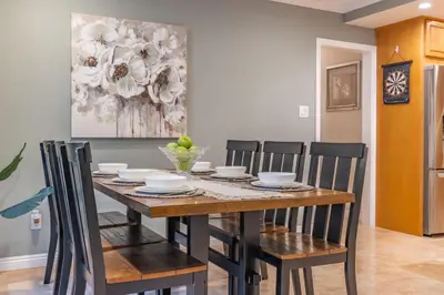 a dining room table with chairs and a painting on the wall at #Marbella Lane - Charming 4BR Bungalo for Relaxing Retreat in Fullerton