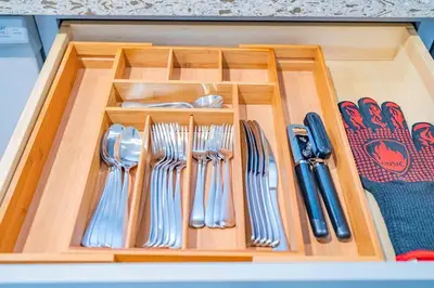 a wooden tray with forks and spoons and utensils at Stylish 2B2B country style house in Glendora