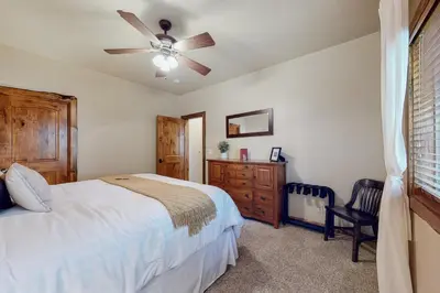 a bedroom with a bed and a ceiling fan at Arrowhead Haven in Lake Arrowhead