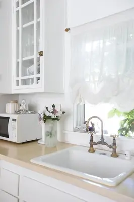 a kitchen counter with a sink and a window at Elegant White Cottage, Venice Beach, California in Los Angeles