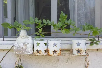 a window sill with a statue and four stars at Elegant White Cottage, Venice Beach, California in Los Angeles