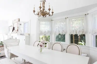 a white dining room with a white table and chairs at Elegant White Cottage, Venice Beach, California in Los Angeles