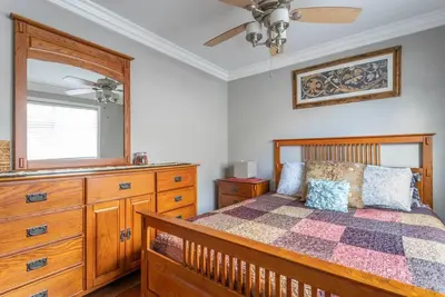 a bedroom with a bed and a dresser and a mirror at Amazing BBQ POOl home at center of LA\u7f8e\u5f0f\u56db\u623f\u5927\u5730\u6cf3\u6c60\u70e7\u70e4\u533a\u7f8e\u5c4b in Chino Hills