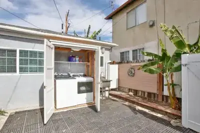a kitchen with a white stove in a backyard at Garden Suite - 10 mins to Beach and LAX in Gardena