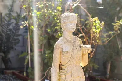 a statue of a woman standing in a garden at Luxury Home - 7mins LAX/Beach, 405/SoFi nearby in Hawthorne