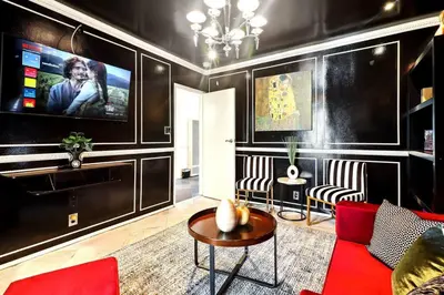 a living room with a red couch and a flat screen tv at Luxury Home - 7mins LAX/Beach, 405/SoFi nearby in Hawthorne