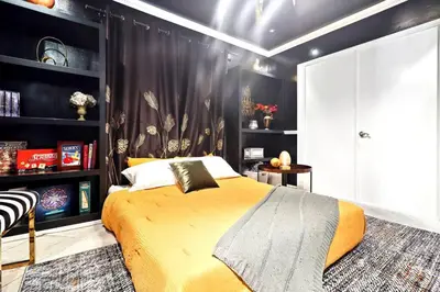a bedroom with a yellow bed and a black wall at Luxury Home - 7mins LAX/Beach, 405/SoFi nearby in Hawthorne