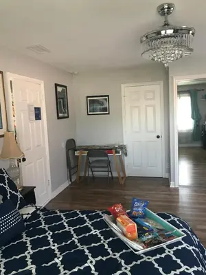 a room with a bed with a tray of food on it at Romantic Coastal Private Room in Oxnard