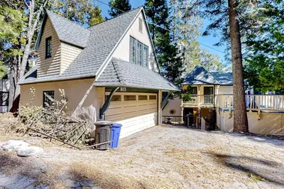 a home with a garage and a house at Vintage Village Walk Cottage in Lake Arrowhead