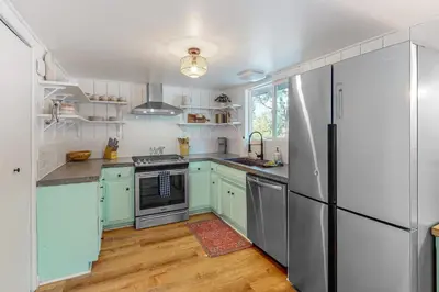 a kitchen with blue cabinets and a refrigerator at Saint Bernard Beauty in Lake Arrowhead