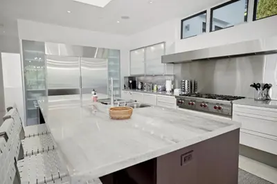 a large kitchen with a large white counter top at Winding Way in Malibu