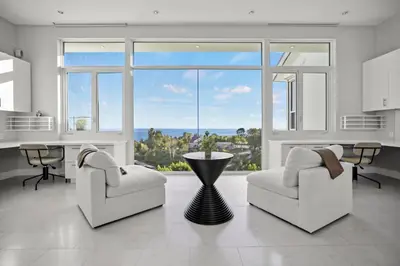 a living room with two chairs and a large window at Winding Way in Malibu