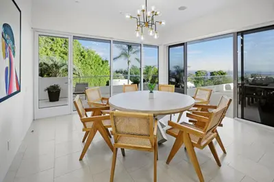 a dining room with a table and chairs at Winding Way in Malibu
