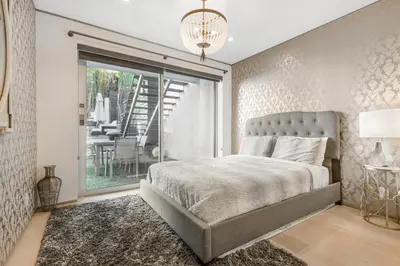 a bedroom with a bed and a sliding glass door at Sunset Heights in Los Angeles