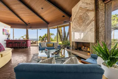 a living room with blue couches and a fireplace at Via Vallarta in Los Angeles