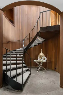a spiral staircase in a room with a wooden wall at Via Vallarta in Los Angeles