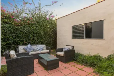 a patio with wicker chairs and a table at Renovated Spanish 3BD 2BA near Beverly Hills in Los Angeles