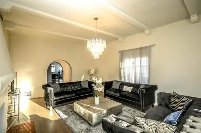 a living room with black furniture and a chandelier at Gorgeous Renovated 3BD 2BA near West Hollywood and Beverly Hills in Los Angeles
