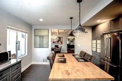 a kitchen with a large wooden table in a room at Gorgeous Renovated 3BD 2BA near West Hollywood and Beverly Hills in Los Angeles